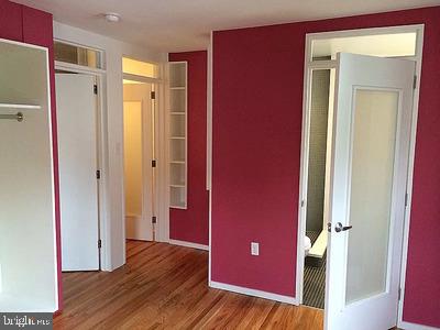 unfurnished bedroom with a closet and wood-type flooring