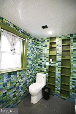 bathroom with tile flooring and toilet