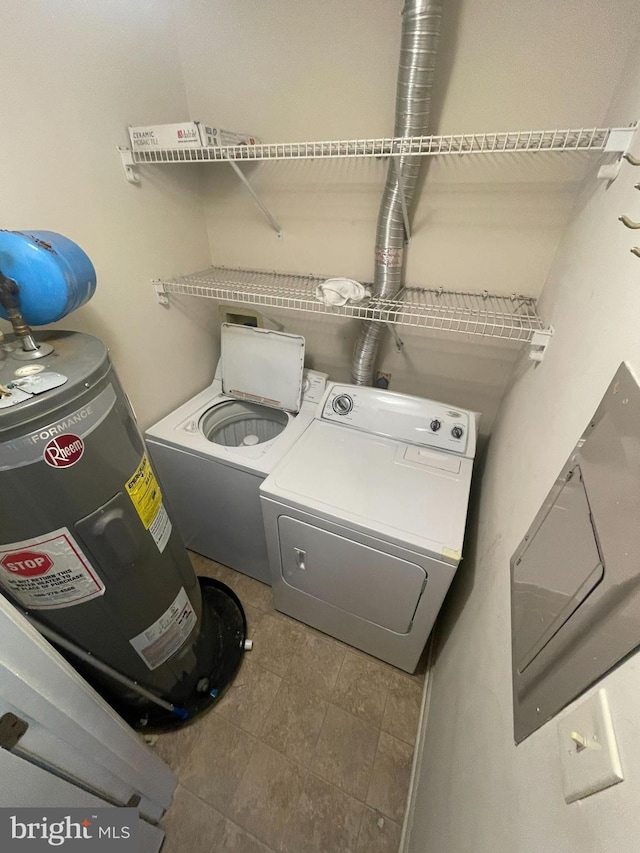 laundry area with electric water heater and independent washer and dryer