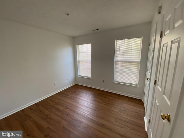 empty room featuring dark hardwood / wood-style flooring