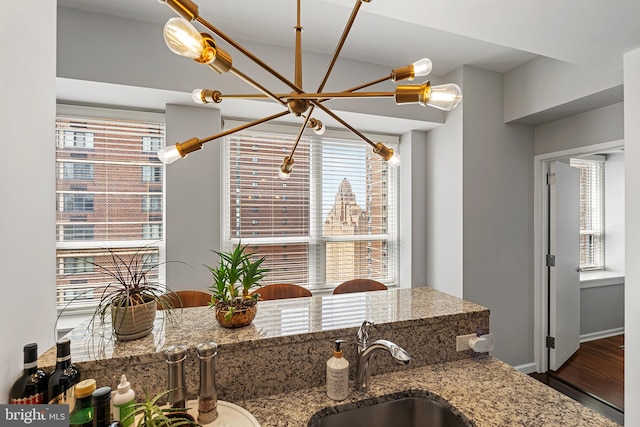 kitchen featuring sink, a healthy amount of sunlight, and hardwood / wood-style floors