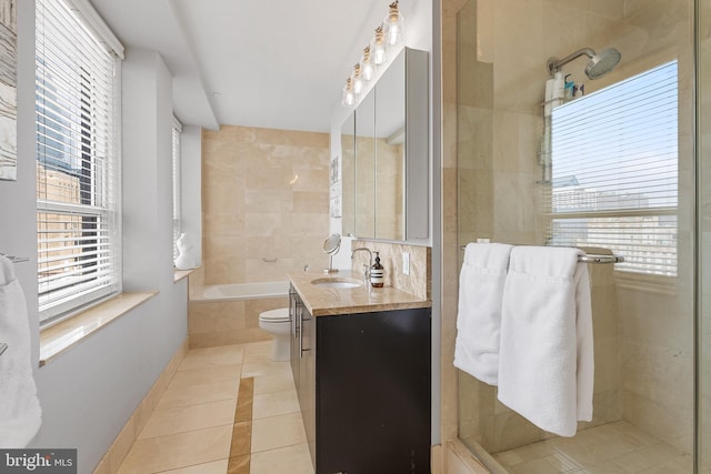 bathroom featuring plenty of natural light, oversized vanity, tile floors, and toilet