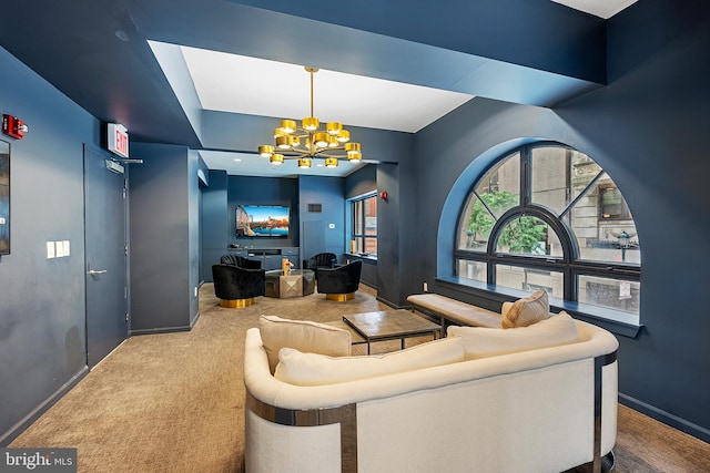 carpeted living room with an inviting chandelier