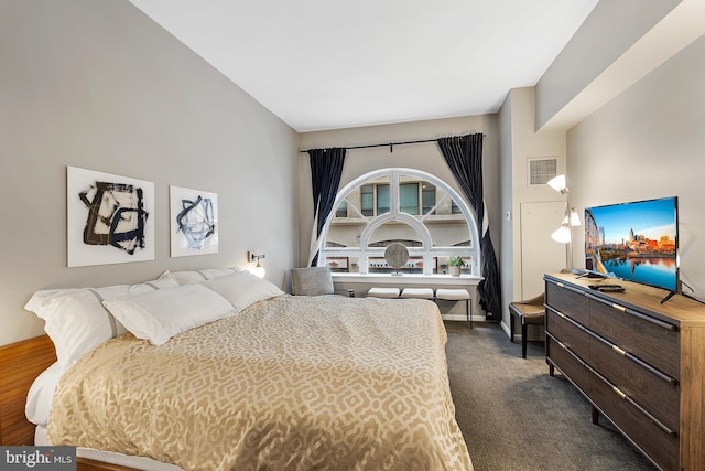 bedroom featuring dark carpet