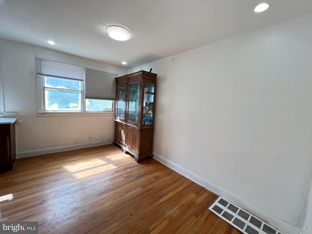 spare room featuring hardwood / wood-style flooring