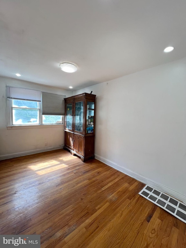 spare room with hardwood / wood-style floors