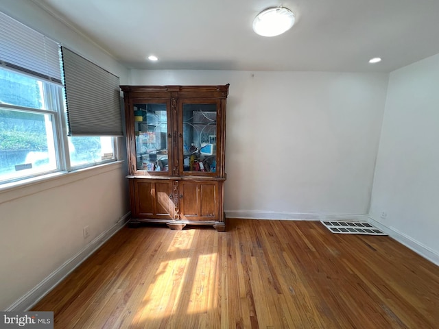 empty room with hardwood / wood-style flooring