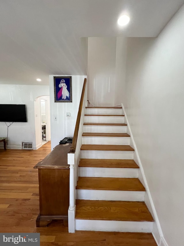 staircase featuring hardwood / wood-style floors