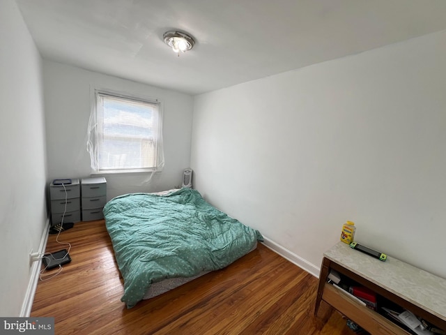 bedroom with wood-type flooring