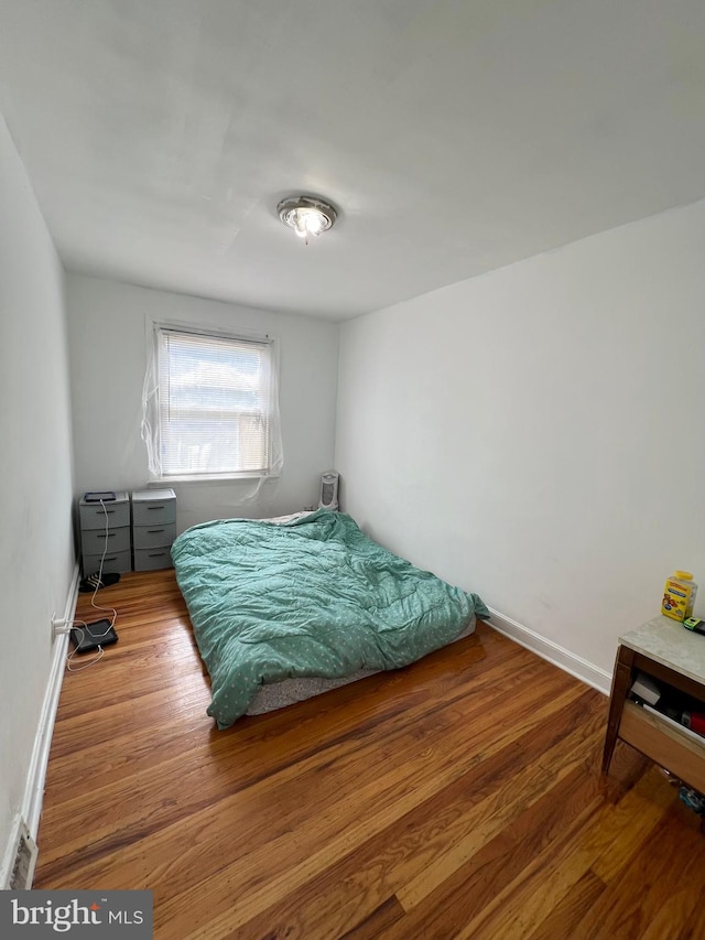 bedroom with hardwood / wood-style floors