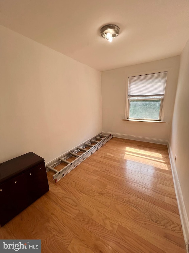 unfurnished room with hardwood / wood-style floors