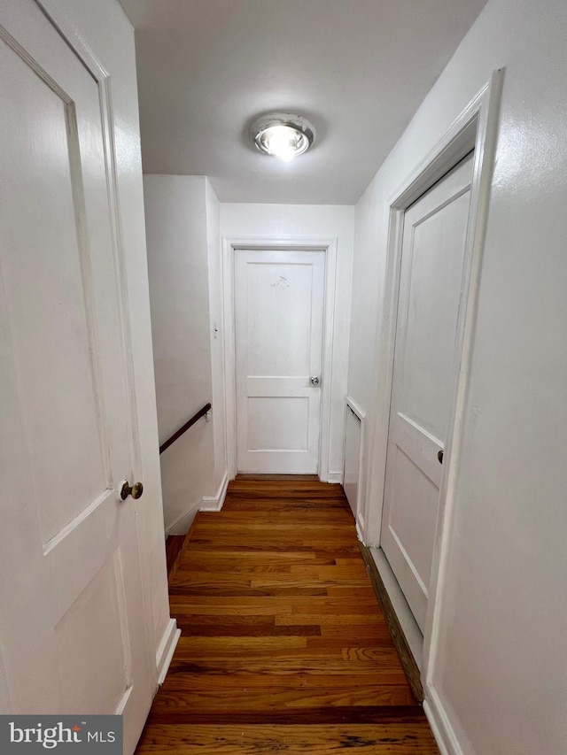 corridor with wood-type flooring