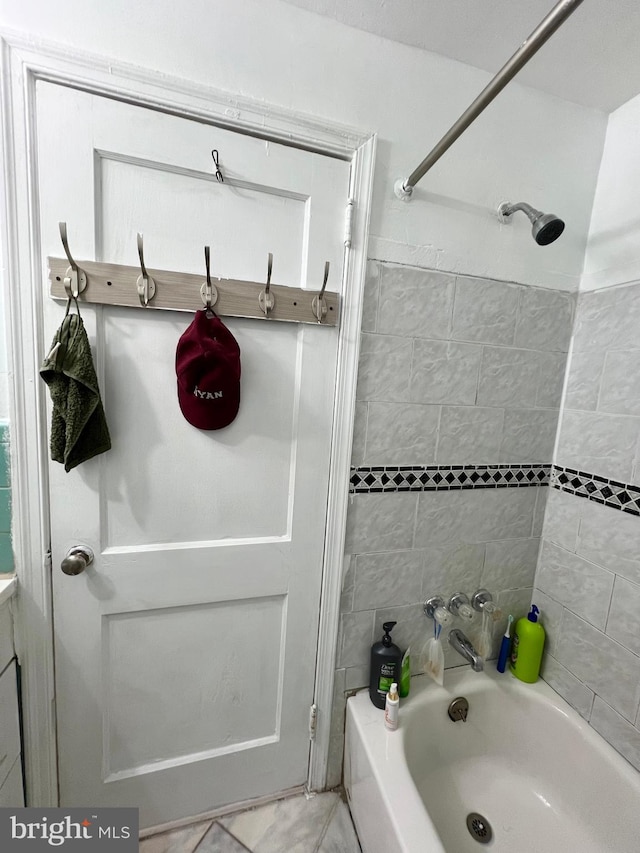 bathroom with tiled shower / bath and tile flooring