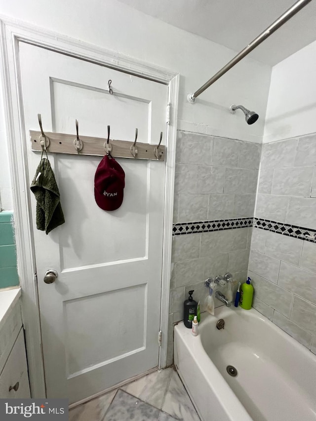 bathroom with tiled shower / bath and tile flooring