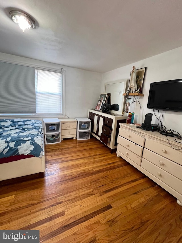 bedroom with hardwood / wood-style flooring