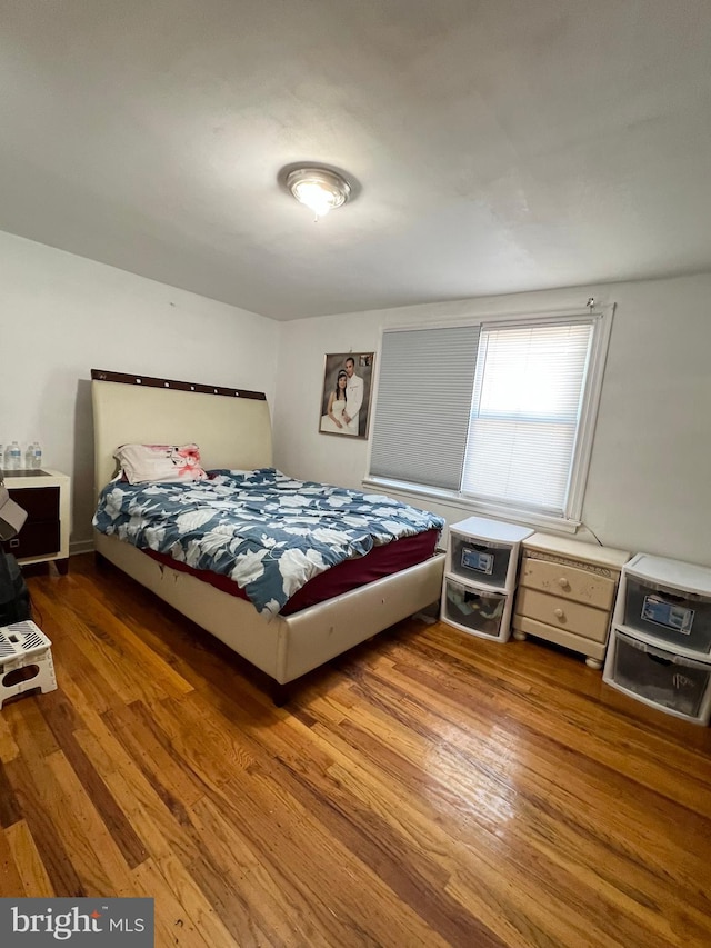 bedroom with hardwood / wood-style flooring