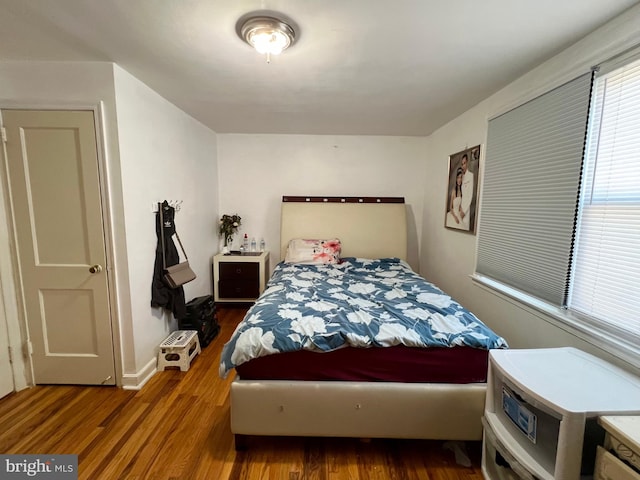 bedroom with dark hardwood / wood-style floors