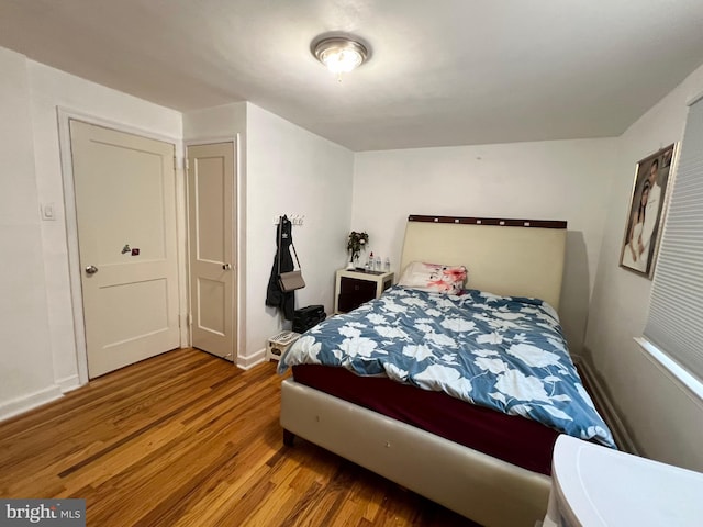 bedroom with wood-type flooring