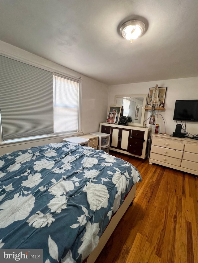 bedroom featuring dark hardwood / wood-style flooring