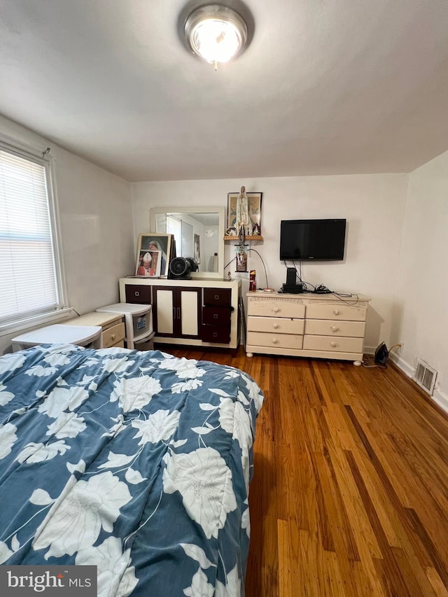 bedroom with dark wood-type flooring