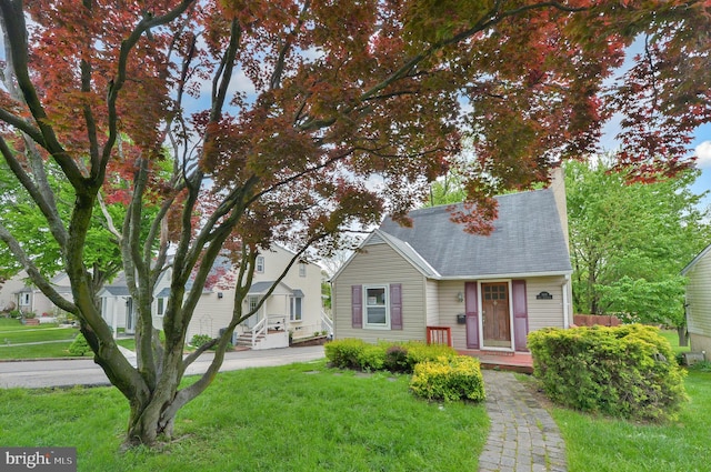 bungalow-style house with a front yard