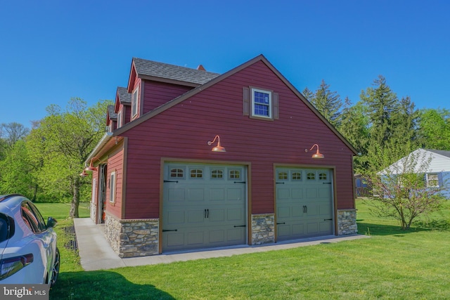 garage featuring a lawn