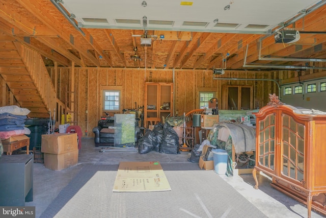 garage with wood walls and a garage door opener