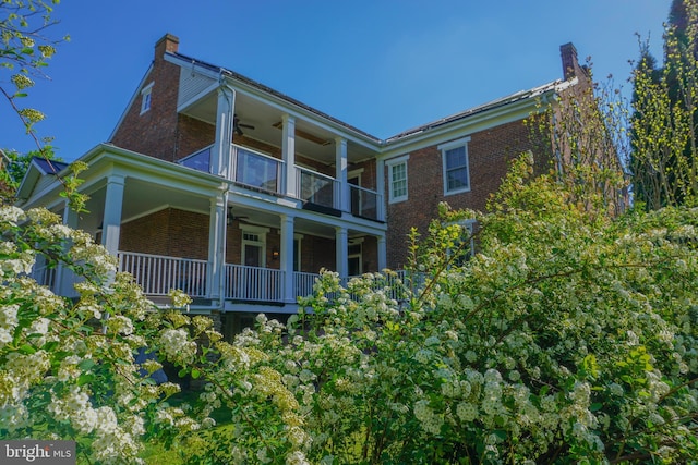 exterior space featuring a balcony and ceiling fan