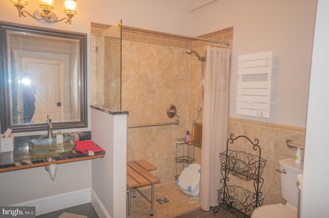 bathroom with tile patterned flooring, a shower with curtain, toilet, and tile walls