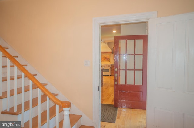 staircase with hardwood / wood-style flooring