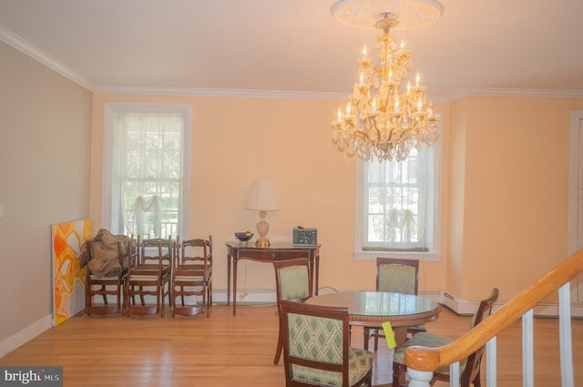 dining space featuring a chandelier, crown molding, and light hardwood / wood-style flooring