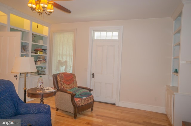 living area with light hardwood / wood-style flooring and ceiling fan