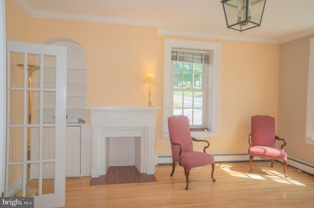 living area with hardwood / wood-style floors and crown molding