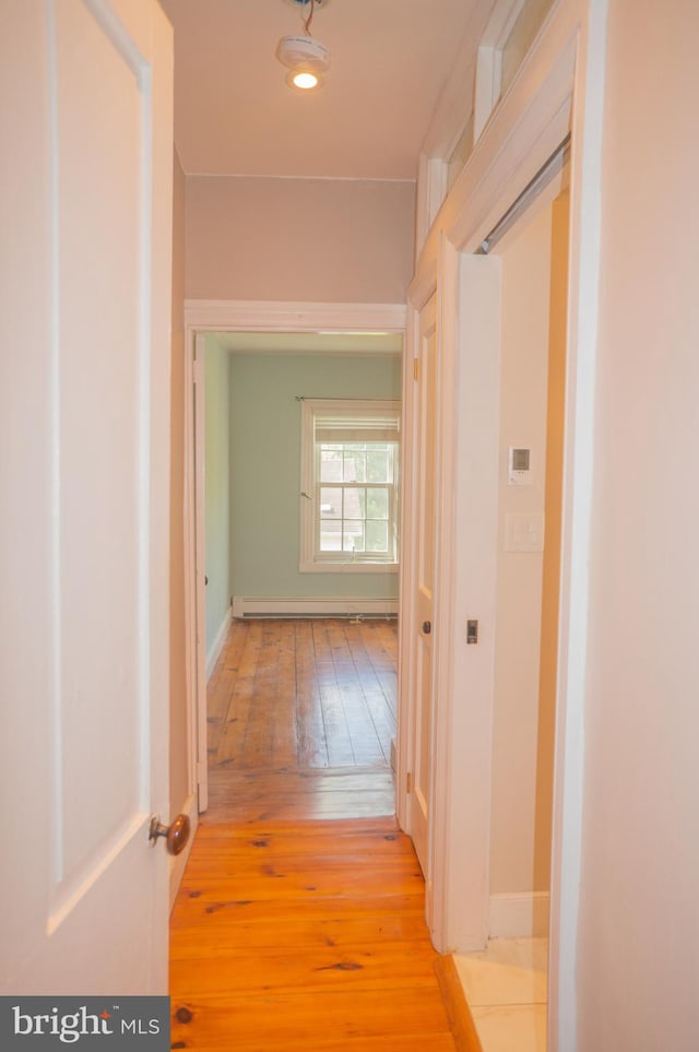 corridor with light hardwood / wood-style flooring