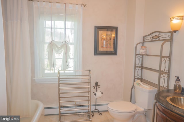 bathroom featuring tile patterned floors, toilet, a baseboard heating unit, and a bathing tub