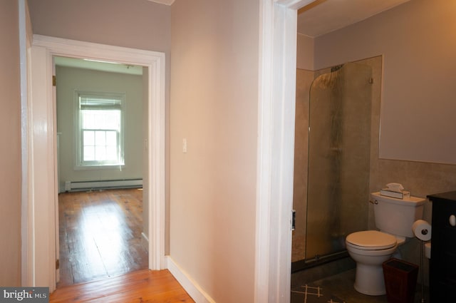 bathroom featuring walk in shower, hardwood / wood-style flooring, toilet, and baseboard heating