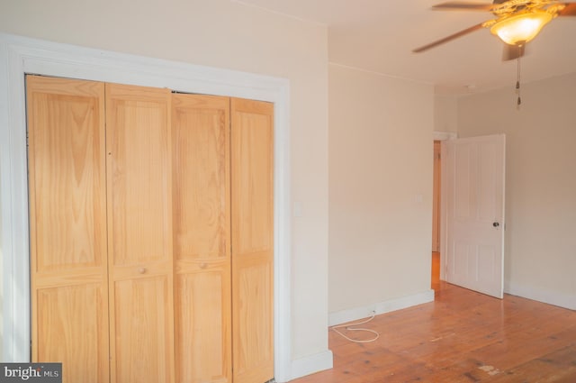 unfurnished bedroom featuring hardwood / wood-style flooring and ceiling fan