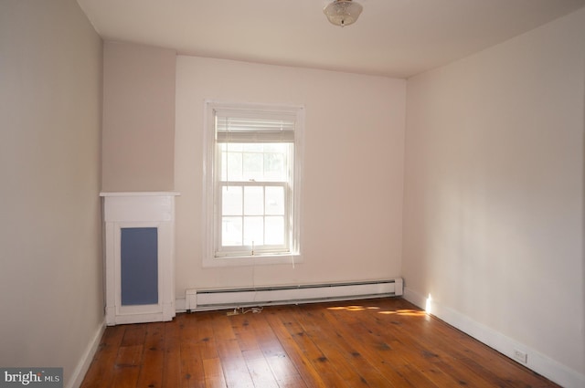 unfurnished room with wood-type flooring and a baseboard radiator