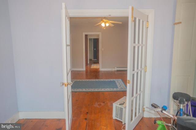 hall featuring wood-type flooring and a baseboard radiator