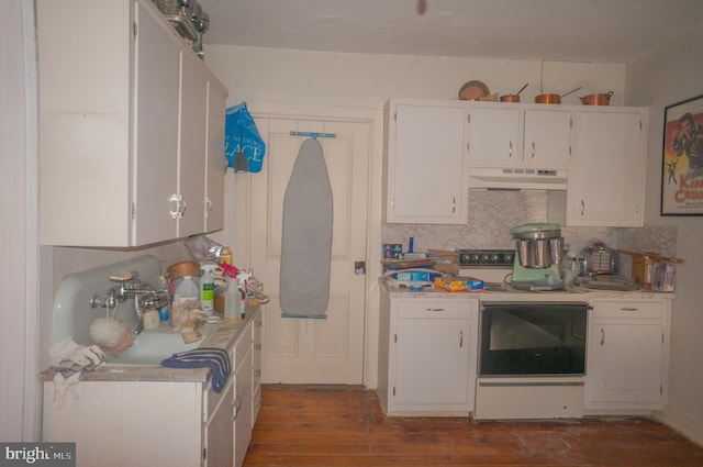 kitchen featuring white cabinets, white range with electric stovetop, light hardwood / wood-style floors, and extractor fan