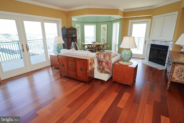 living room with crown molding, dark hardwood / wood-style floors, and a premium fireplace