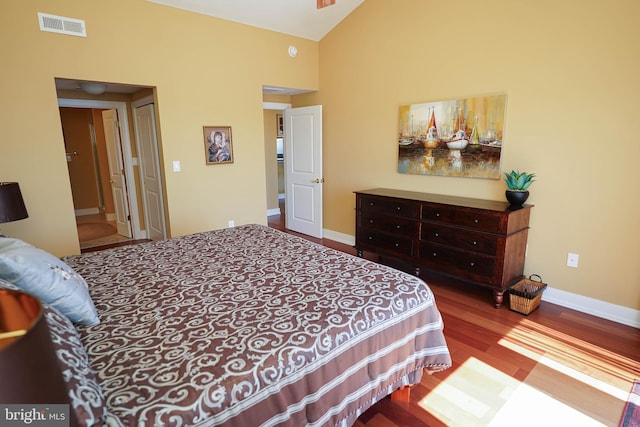 bedroom featuring high vaulted ceiling and wood-type flooring