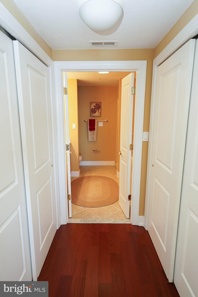 corridor featuring dark hardwood / wood-style floors