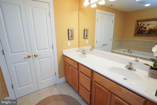 bathroom with tile flooring, dual vanity, and a tub