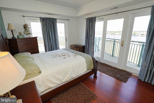 bedroom featuring crown molding, access to exterior, and dark wood-type flooring