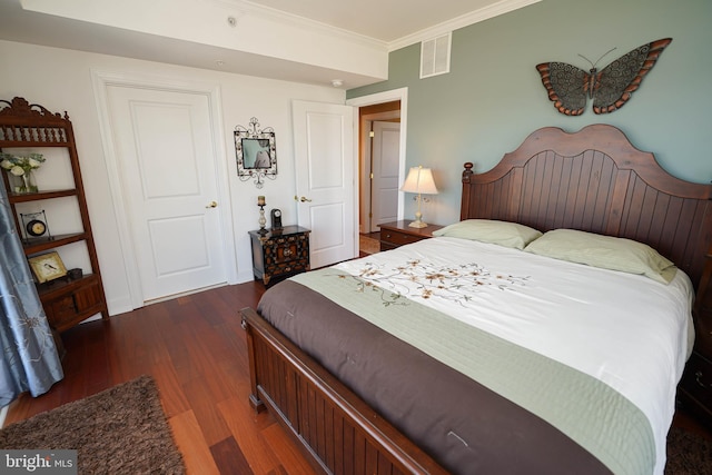 bedroom with hardwood / wood-style floors and crown molding