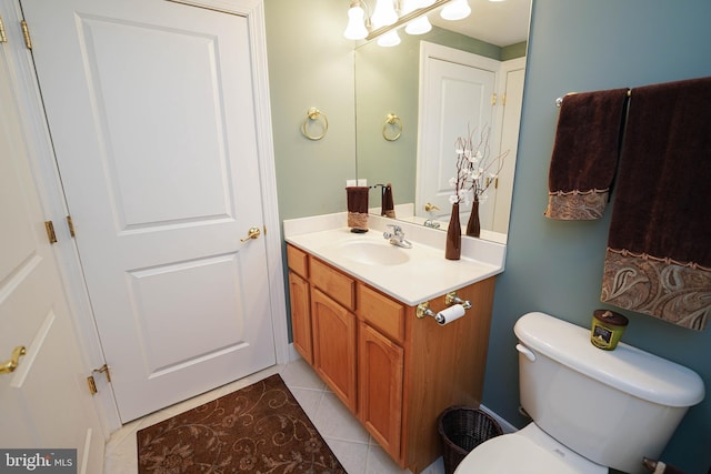 bathroom featuring vanity, tile floors, and toilet