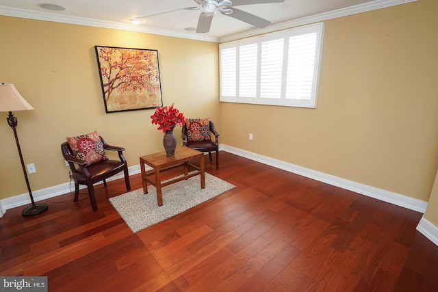 living area with ceiling fan, dark hardwood / wood-style flooring, and ornamental molding