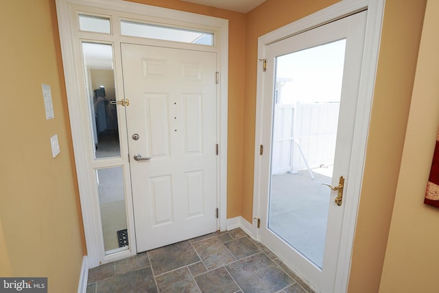 entryway with dark tile floors