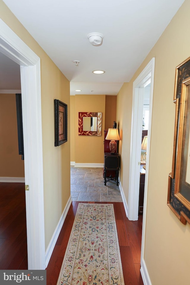 corridor with dark hardwood / wood-style floors